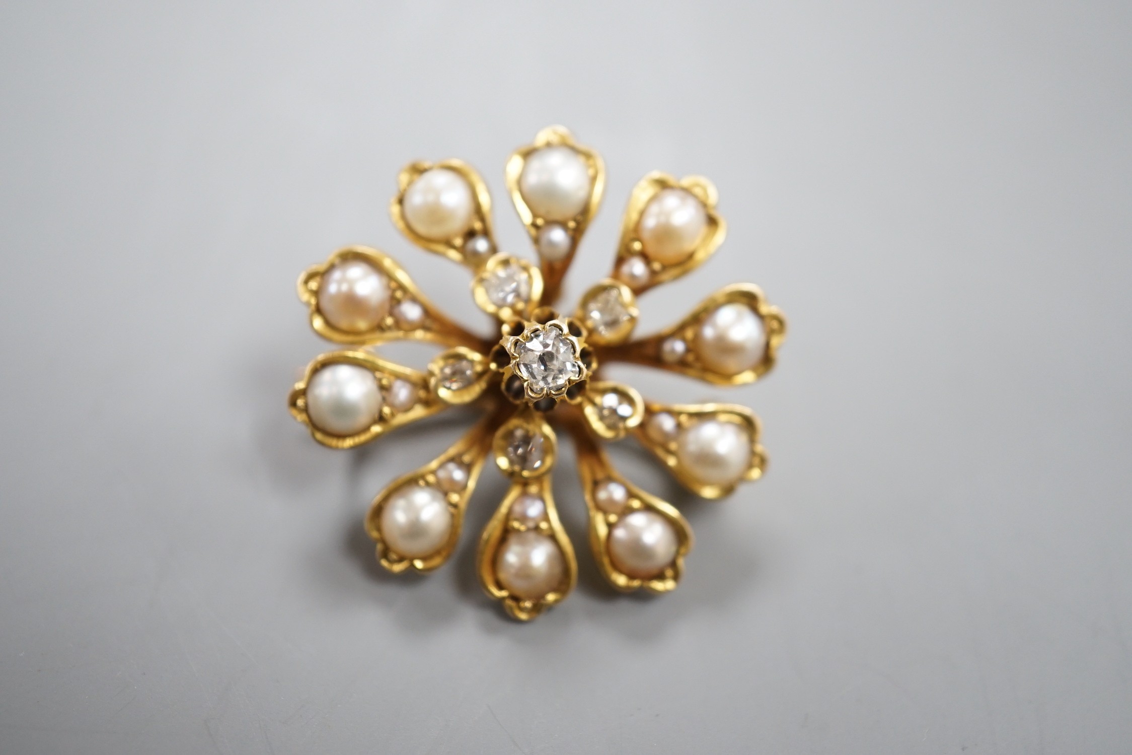 A Victorian yellow metal (tests as 15ct), diamond and split pearl set pendant brooch, 26mm, gross weight 6.9 grams.